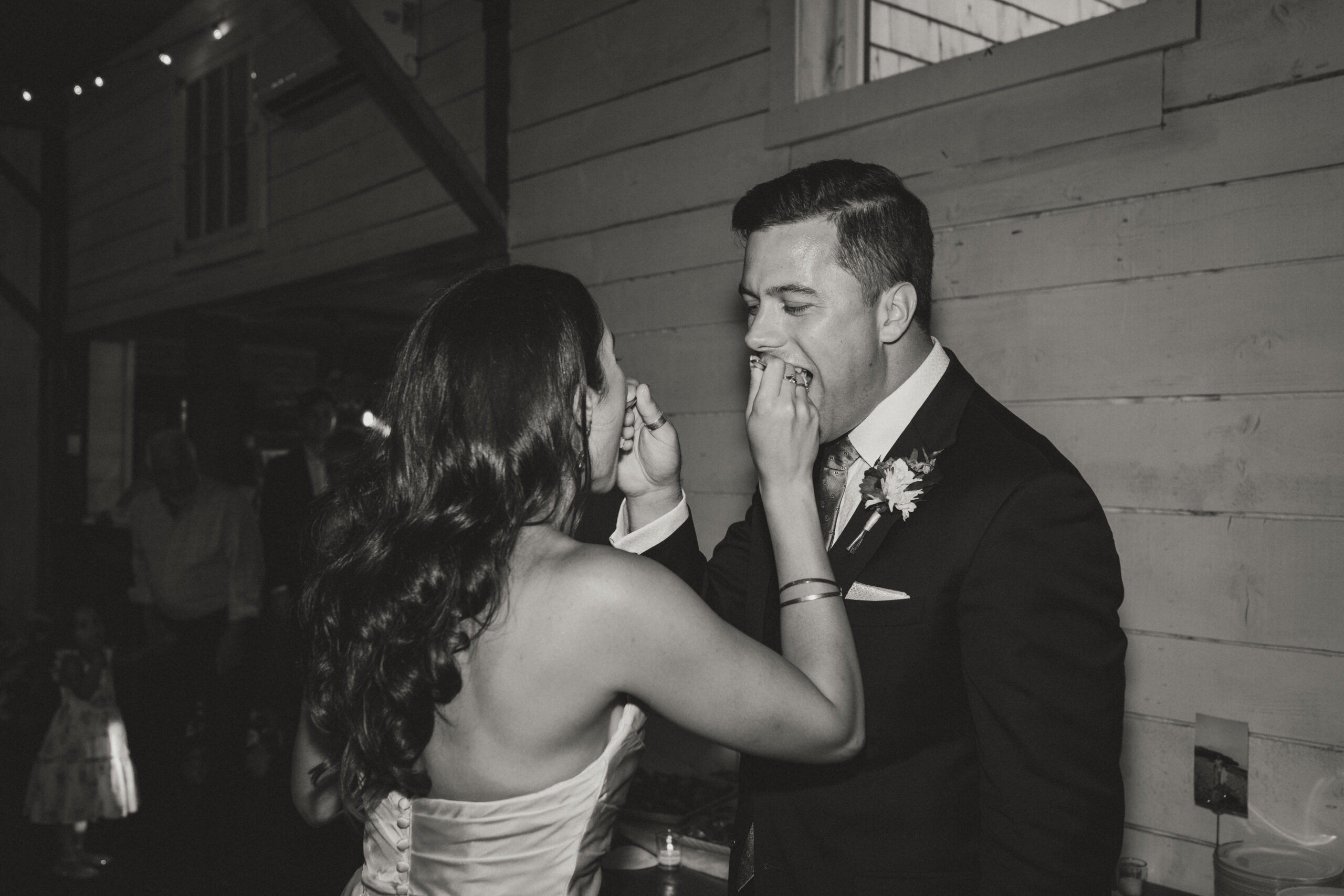 bride and groom feeding each other cake