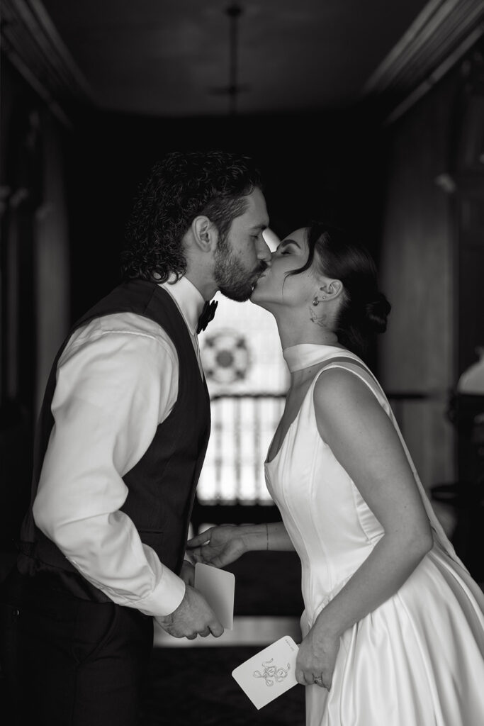bride and groom kissing in black and white