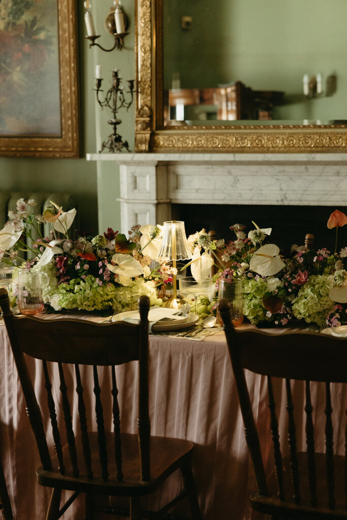 photo of wedding dinner table with lamps, flowers, grapes