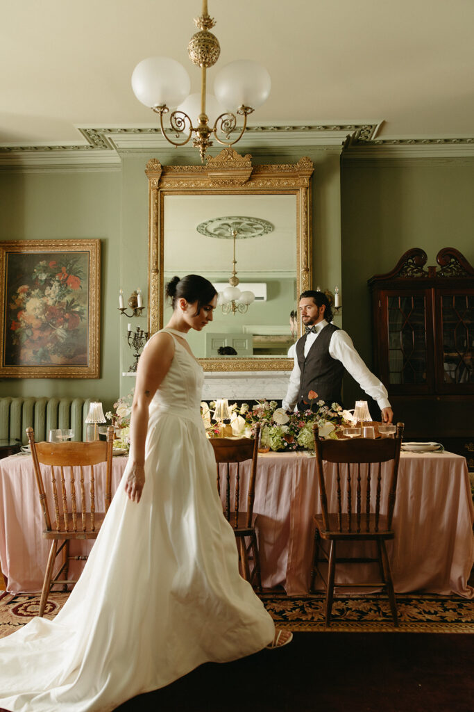 bride and groom blurry walking past wedding table