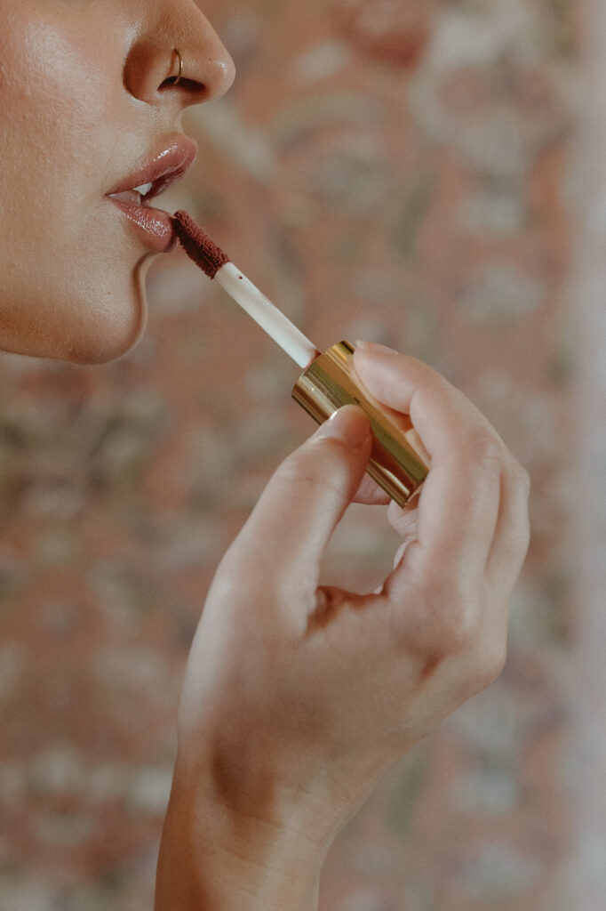 bride putting on lipgloss up close