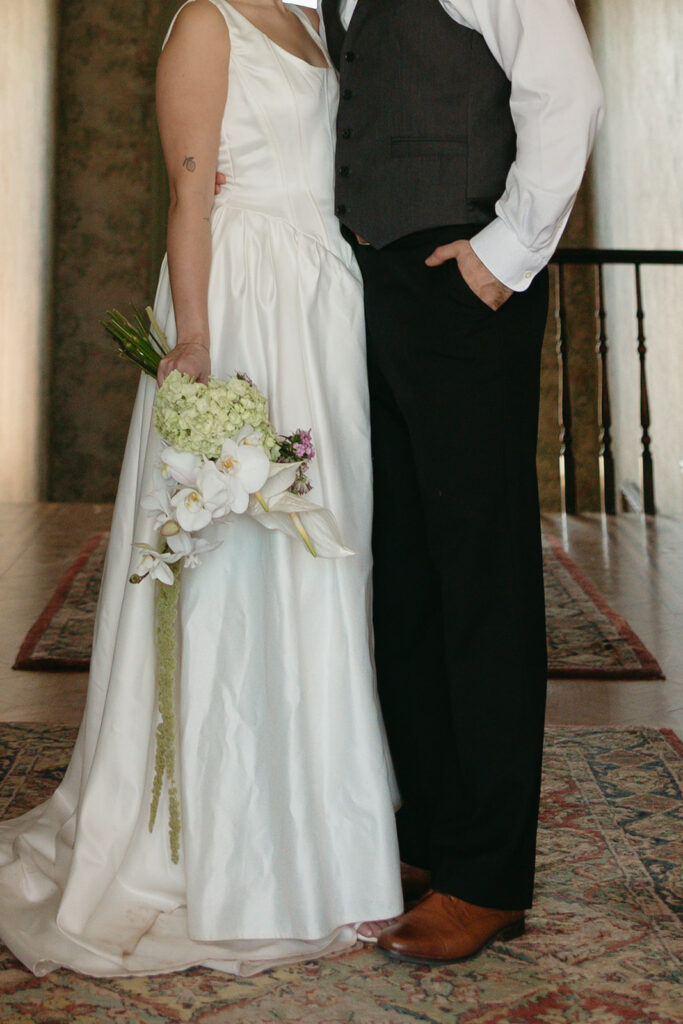 bride and groom close up holding wedding bouquet