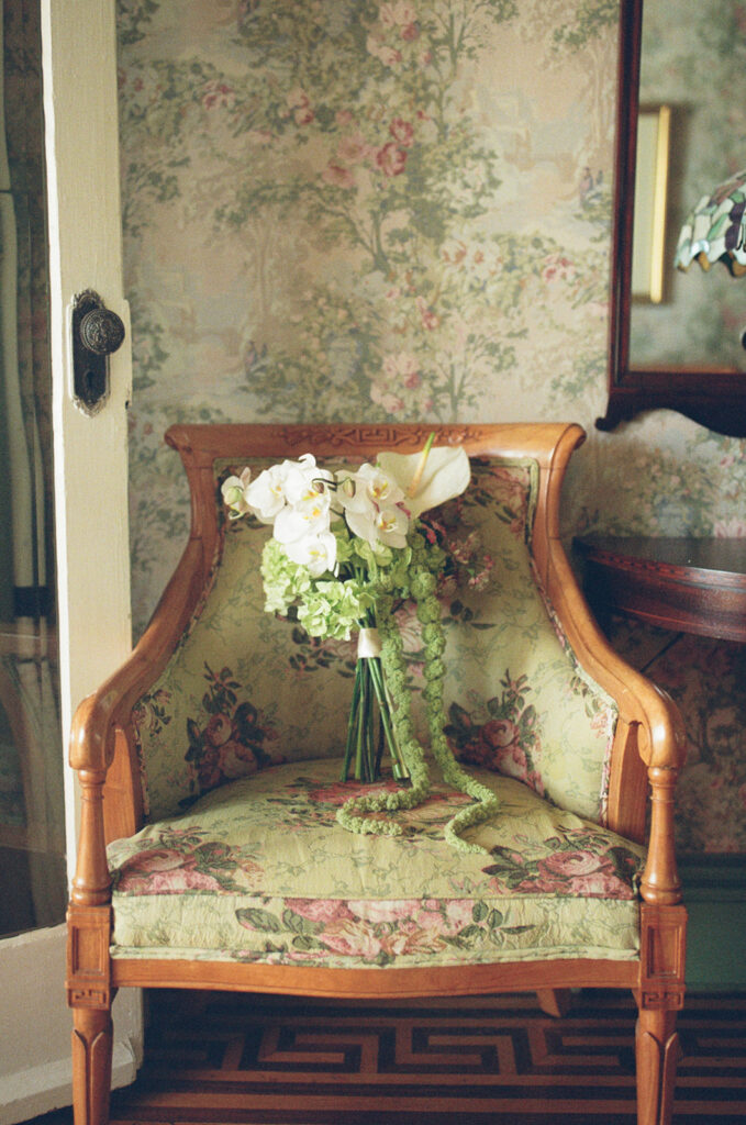 film photo of bridal bouquet on vintage chair in vintage inn