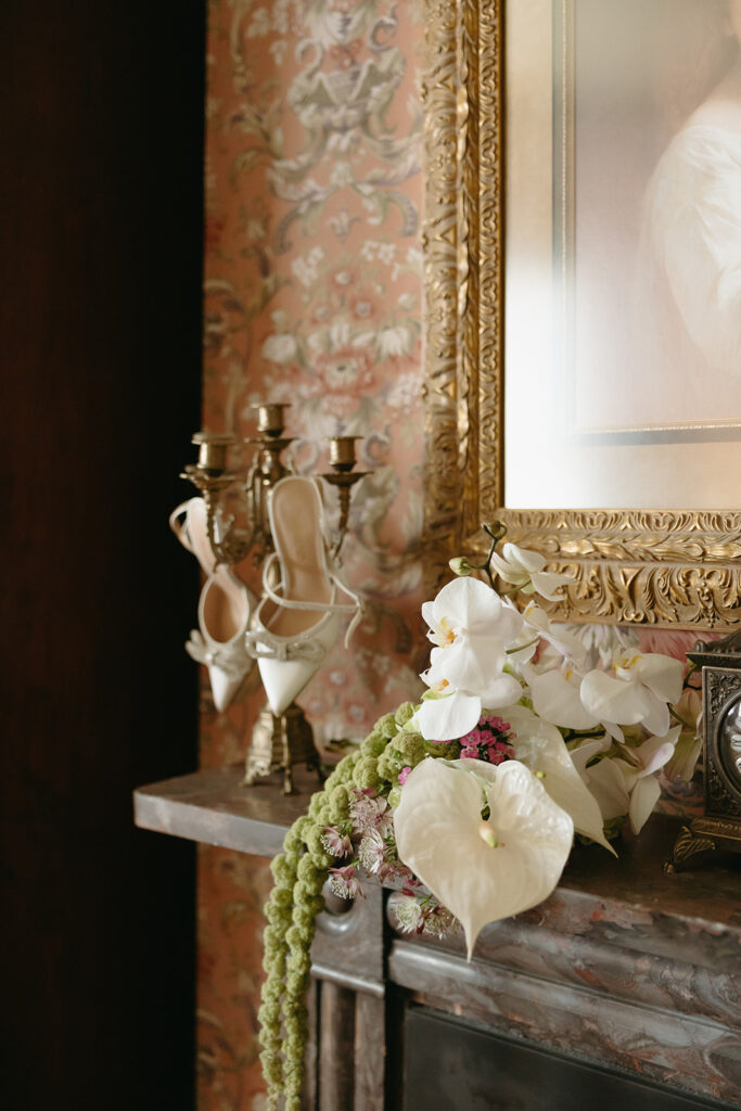 bridal bouquet and shoes on mantle in getting ready suite